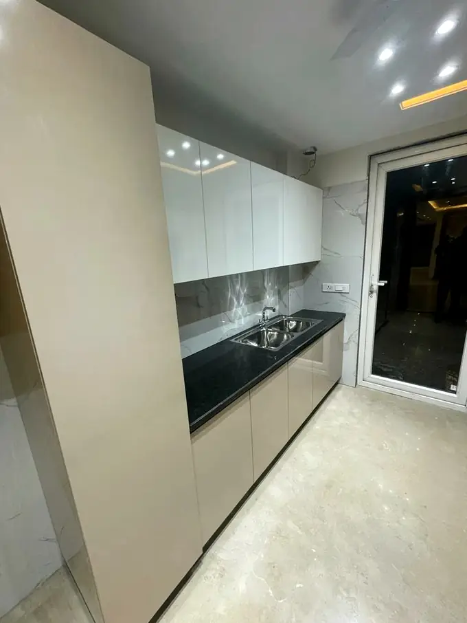 Modular kitchen in white gloss with a dark stone counter