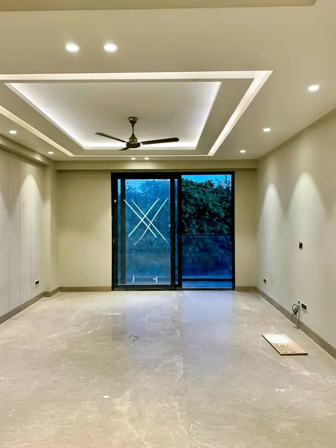 Empty flat with a newly built false ceiling and cove lighting, no furniture yet